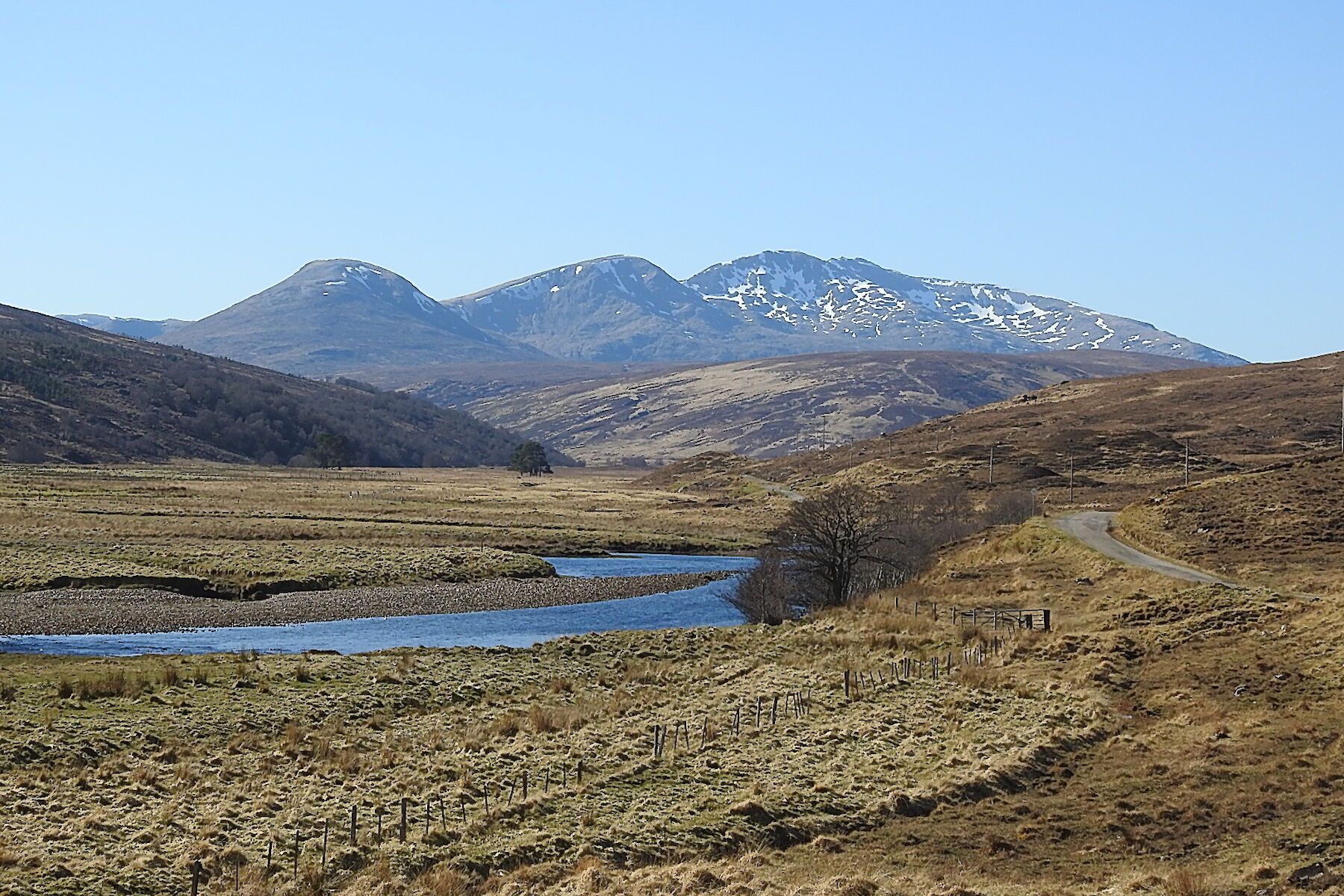 Rosehall image: snow-dotted mountains in distance across wide open landscape