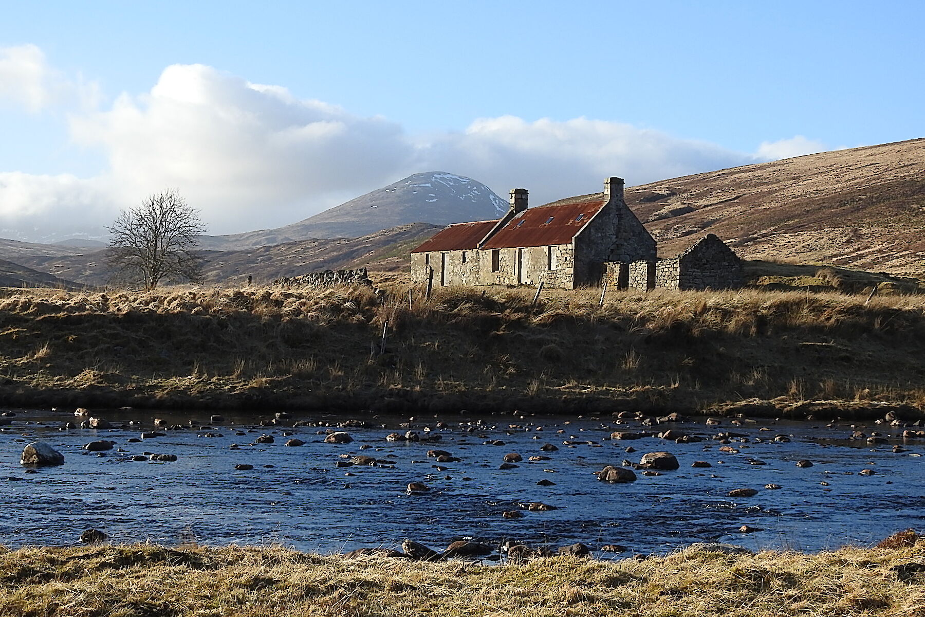 Rosehall image: abandoned cottage at the side of a remote wild river
