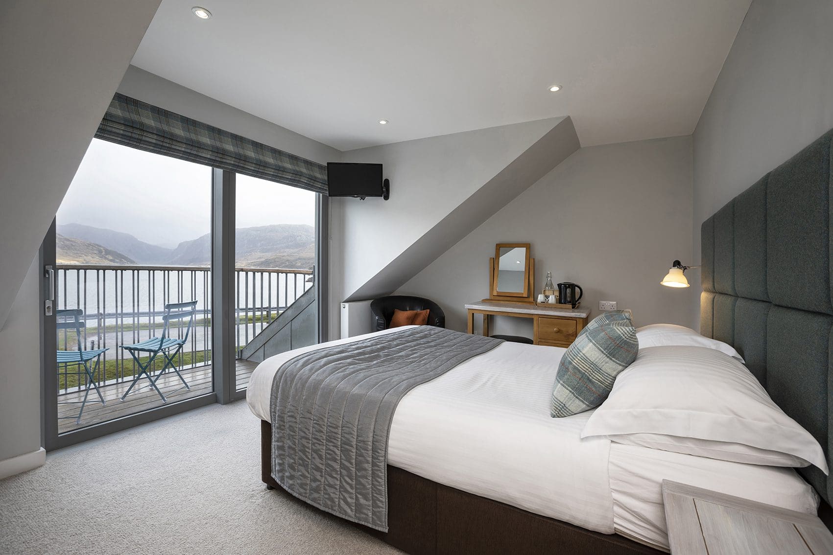 A double bedroom in Kylesku Hotel overlooking stunning highland romantic scenery of mountains and lochs.