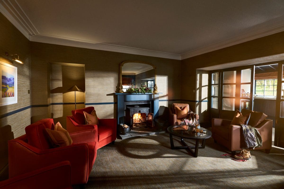 A romantic setting in the lounge in the Varrich Bar & Restaurant, in the Tongue Hotel, Scottish Highlands with a roaring log burner. 