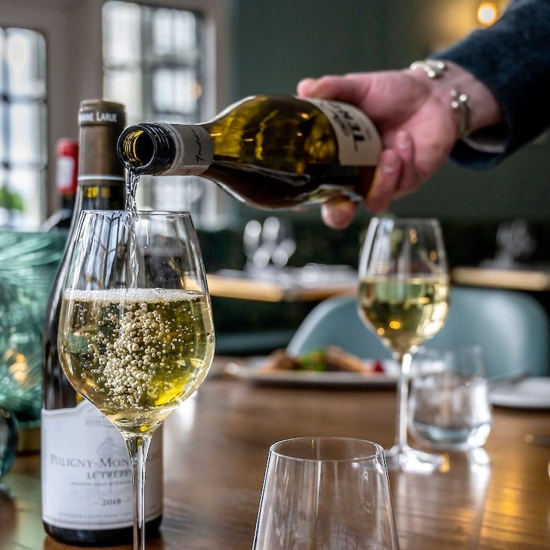 Glasses of white wine being poured at the Royal Marine Hotel, Brora, East Sutherland, North Highlands