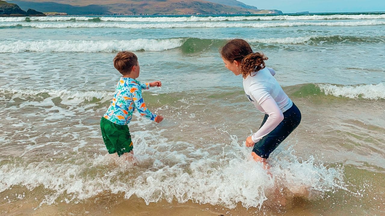 Two children playing in the ocean, at Balnakeil Beach, Sutherland, Scotland, nature and outdoors in the North Highlands
