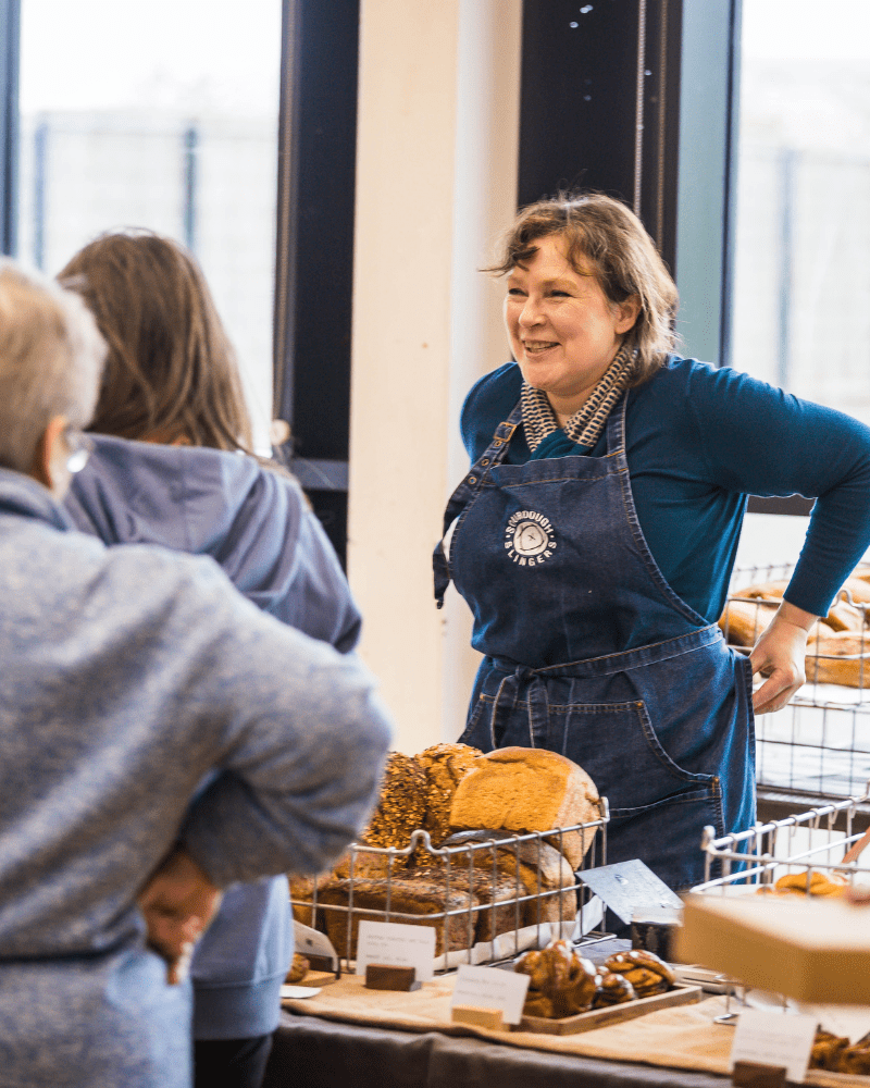 Woman manning the stall for Sourdough Slingers at Taste North, in Wick.