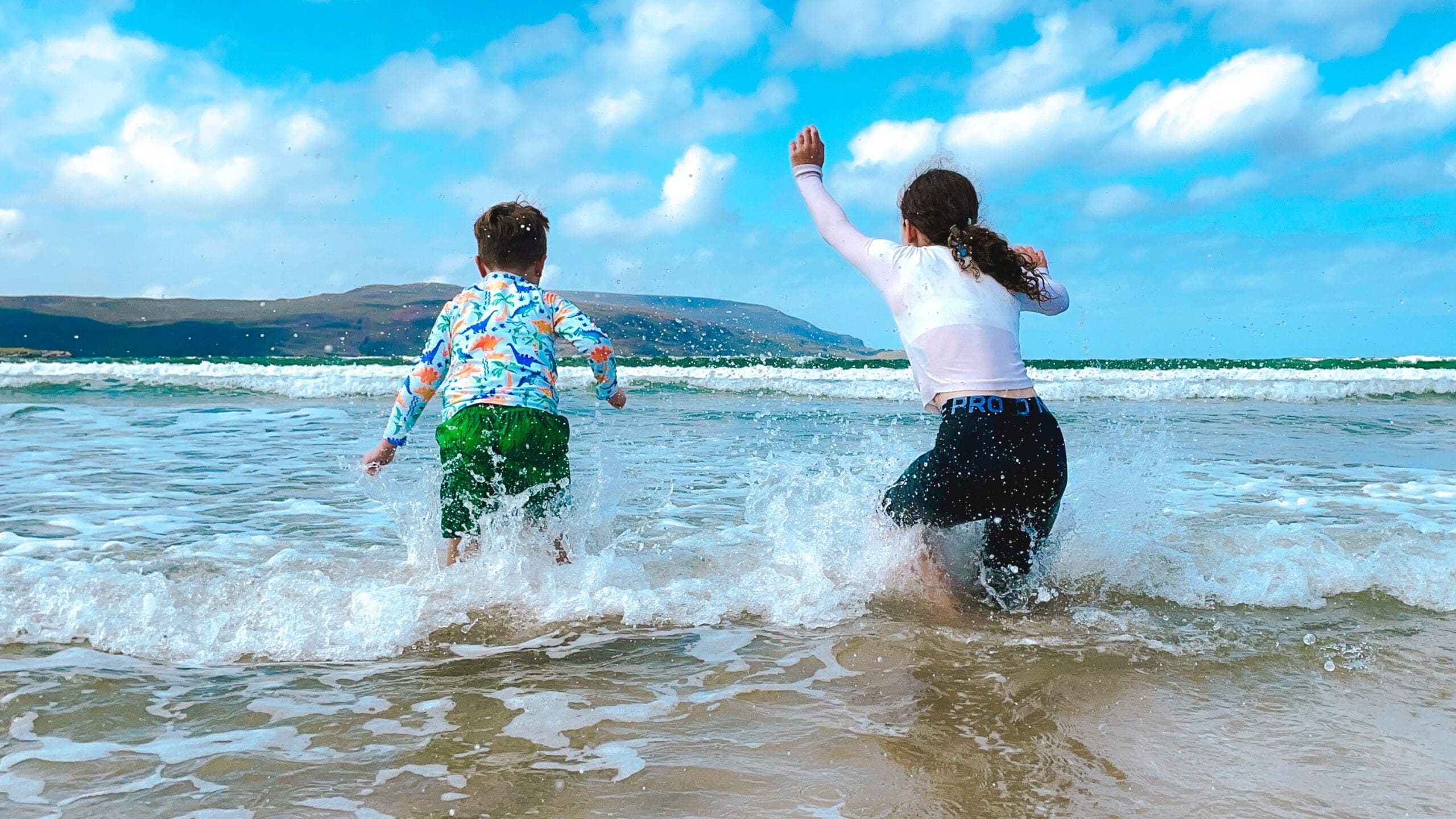Children playing in the seat at Balnakeil Beach, West Sutherland, North Highlands