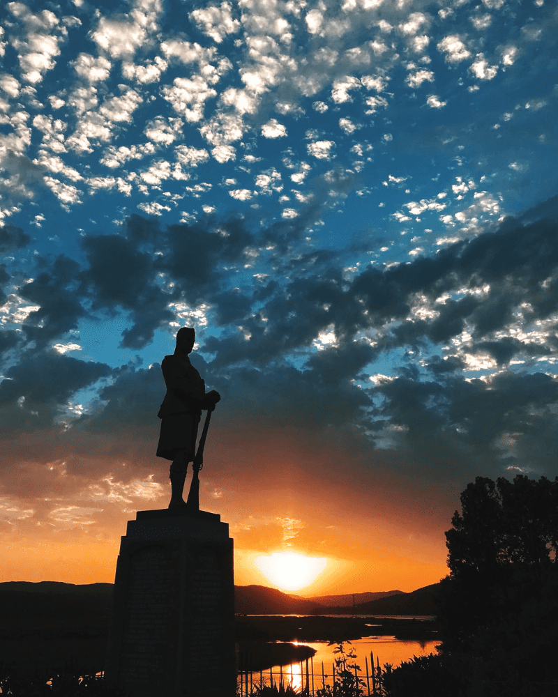 The War Memorial at Bonar Bridge, in Sutherland. The setting sun cast the memorial in shadow.