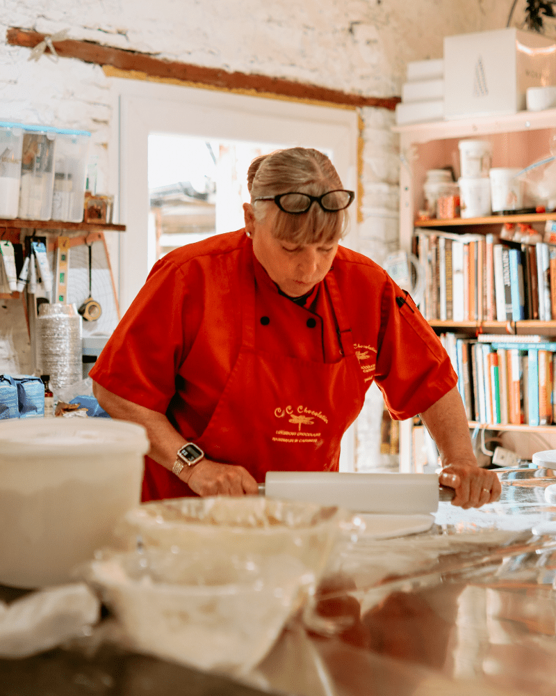 A woman at CC Chocolatier, rolling out some pastry dough