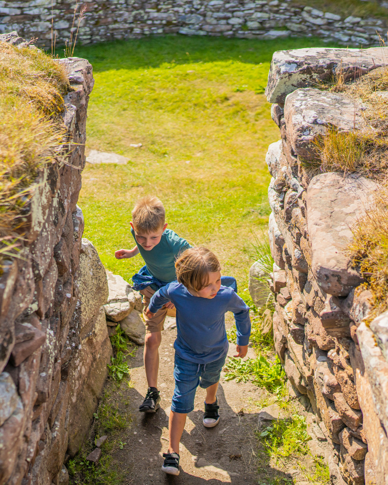 Two young children exploring Cairn Laith Broch, East Sutherland, North Highlands