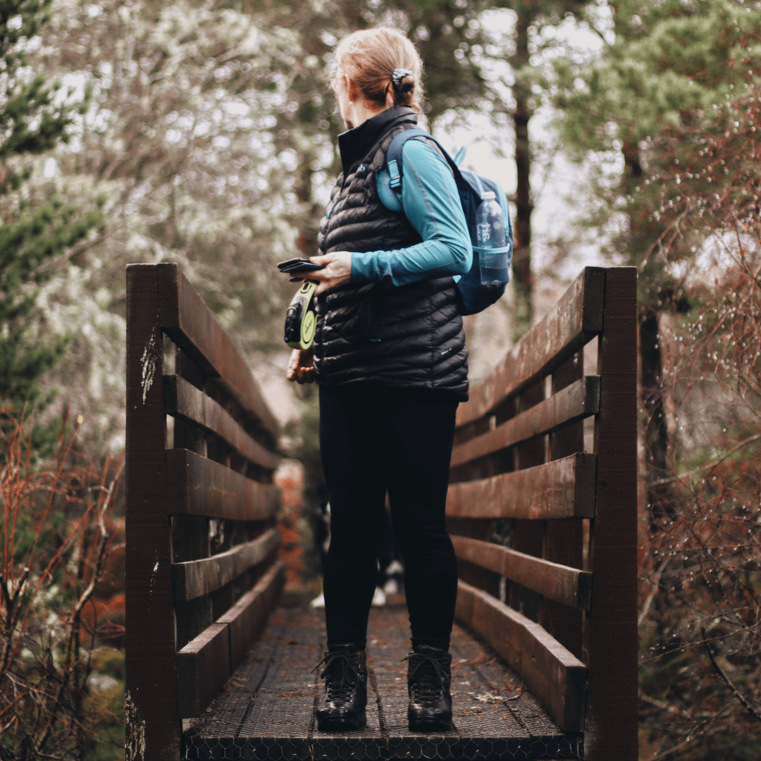 Walking across a small scenic bridge at Carbisdale Forest Walk, Central Sutherland, North Highlands
