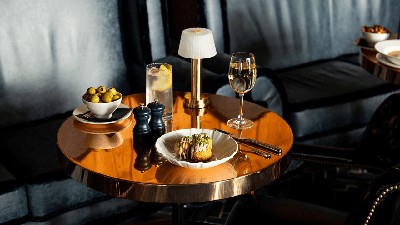 A coffee table with drinks, olives, and Haggis bonbons, in Dornoch, Scotland