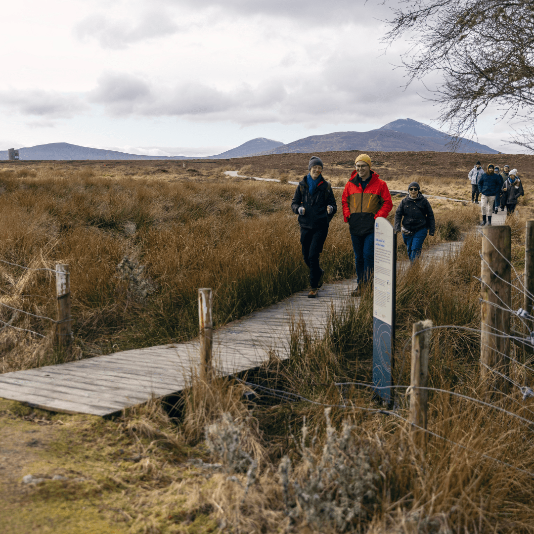 Walking over a rustic bridge in Forsinard, Sutherland, North Highlands. Walking in the North Highlands