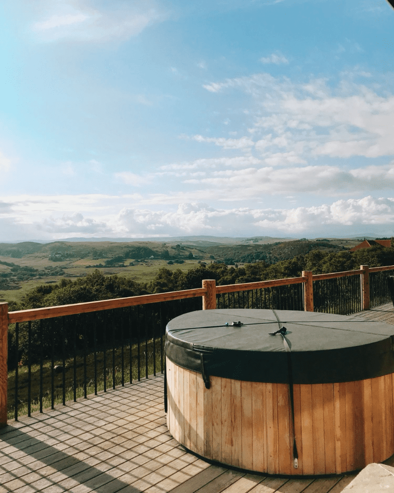 Hot tub looking out onto rolling green hills, Highland Luxury Cottages, Rogart, Central Sutherland, North Highlands