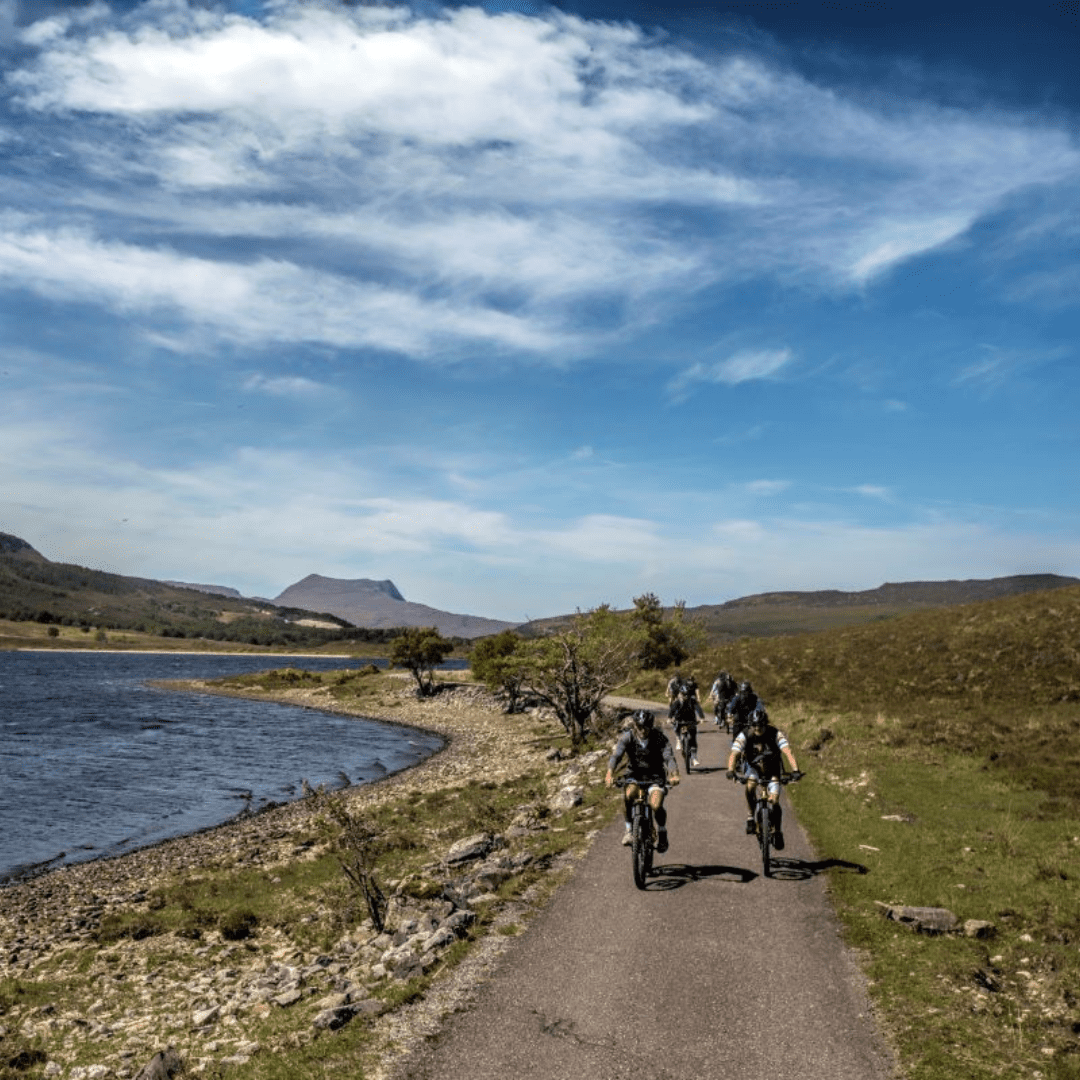 Cycling by a loch in Sutherland, North Highlands. Walking and cycling in the North Highlands, West Sutherland