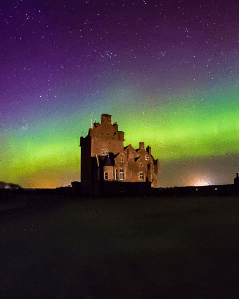 Ackergill Tower, with Nothern lights, a beautiful display of green and purple. In Caithness, Scotland. nature and outdoors in the North Highlands