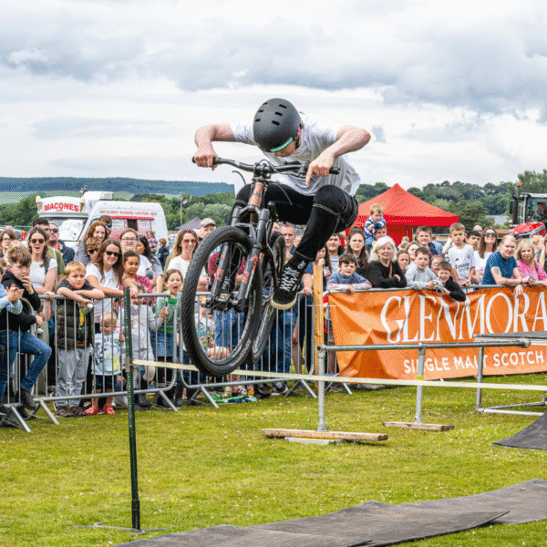 Young boy doing stunts on a motorbike at Scottish agricultural Sutherland Show, North Highlands