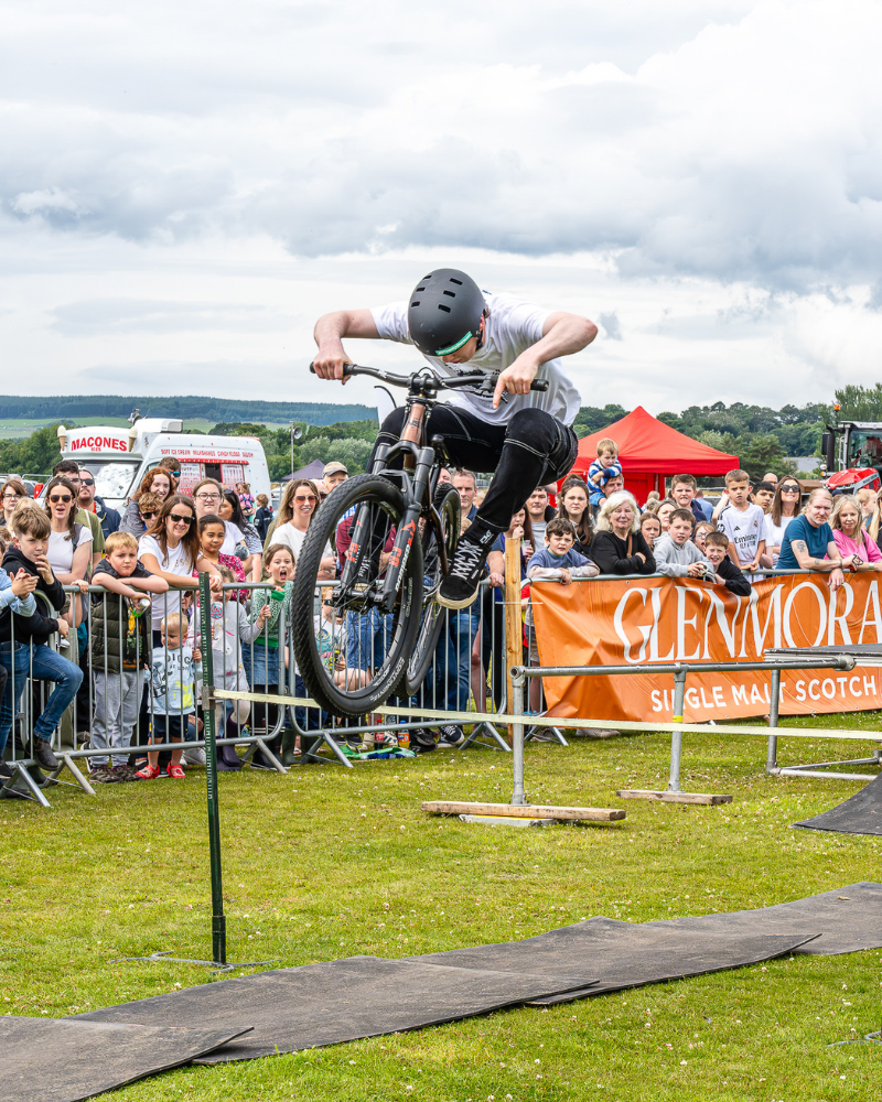 Young boy doing stunts on a motorbike at Scottish agricultural Sutherland Show, North Highlands
