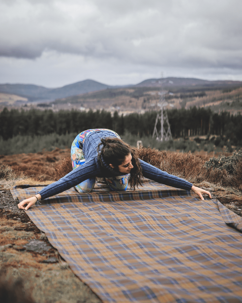 Hannah MacFarlane, from Thistle and Cloth, measuring cloth in Sutherland, Scotland.
