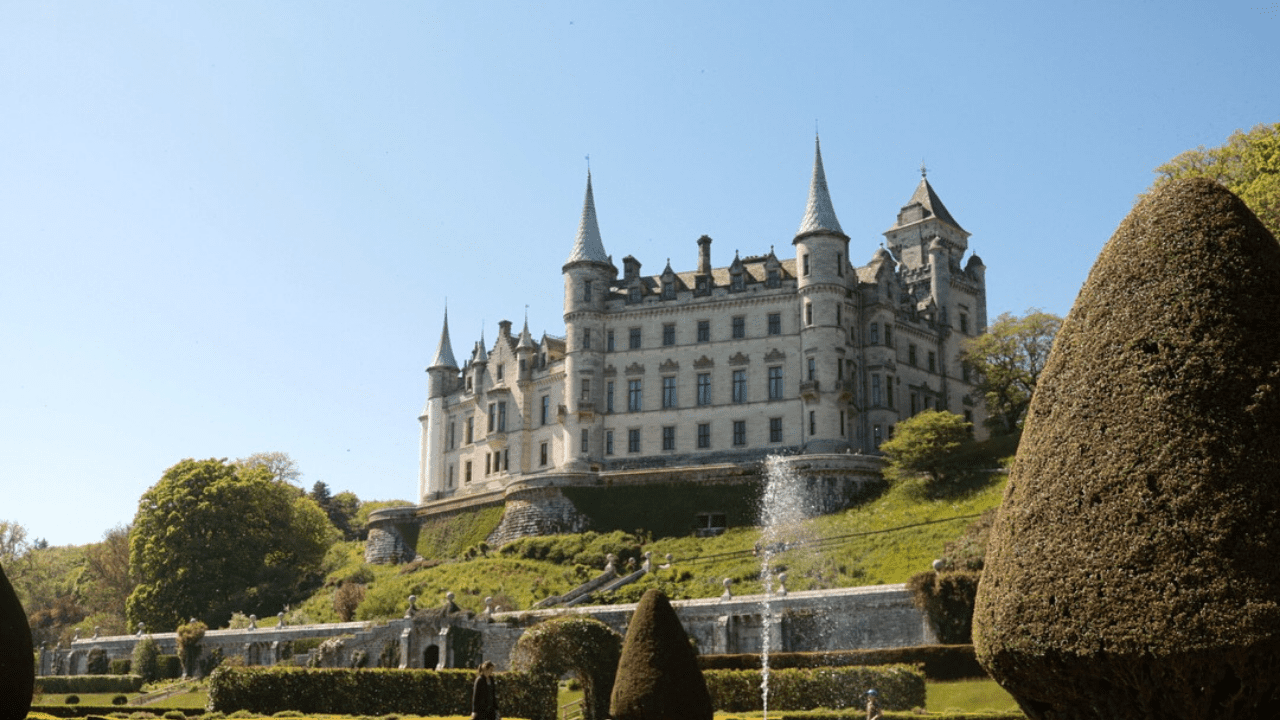 Dunrobin Castle, viewed from the gardens, a fountain in the forground, the castle overlooking the gardens. In Sutherland, Scotland. Attractions and landmarks.