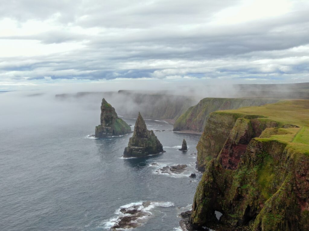 Winter view of Duncansby Stacks at John O’Groats, Caithness, featuring towering sea stacks, rugged cliffs, and the North Sea under a winter sky.