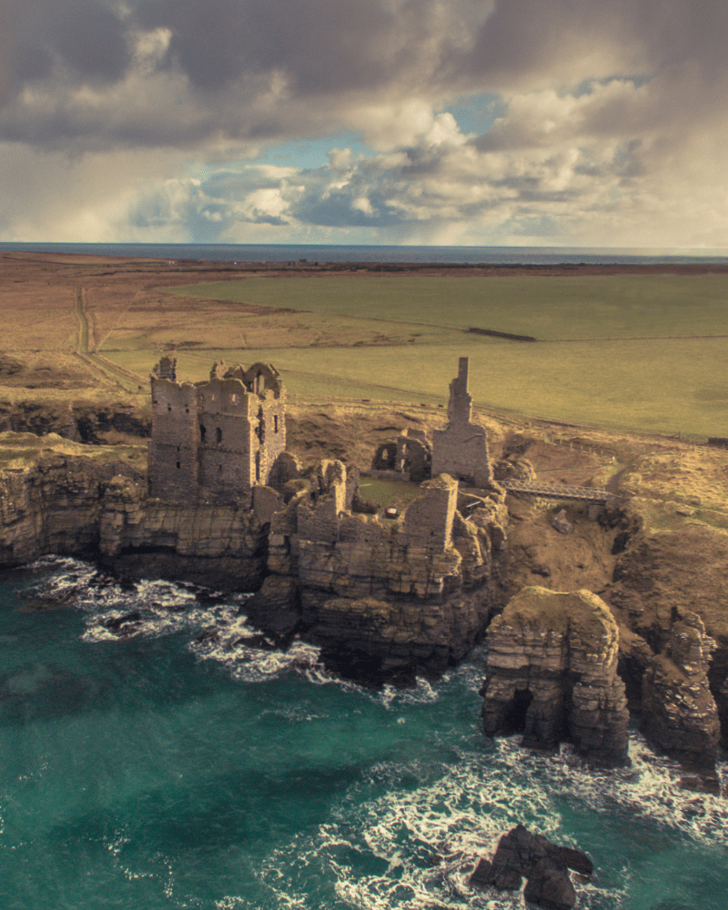 An aerial picture of Castle Sinclair, with the cliffs and sea in view. In Girnigoe, Caithness, Scotland.