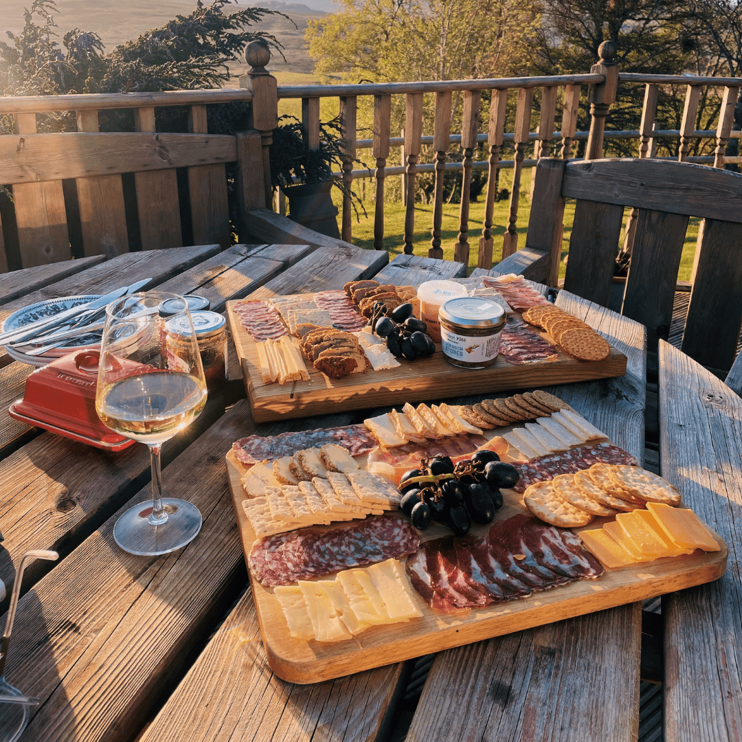 Two charcuterie boards and a glass of white wine, from Clyth Charcuterie located in Caithness