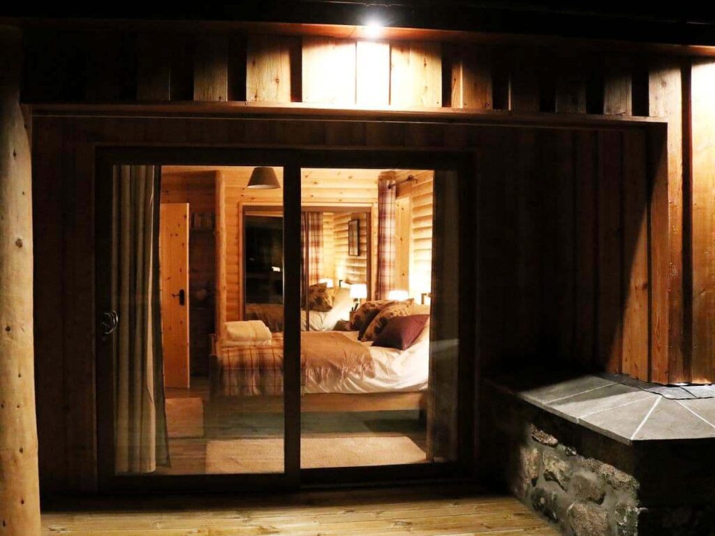 Looking through a window into a cozy bedroom