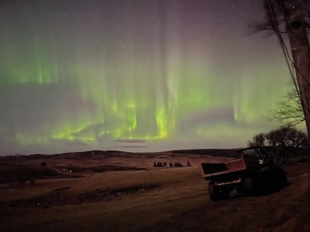 Northern lights over a wide landscape, in Rogart, Sutherland, North Highlands