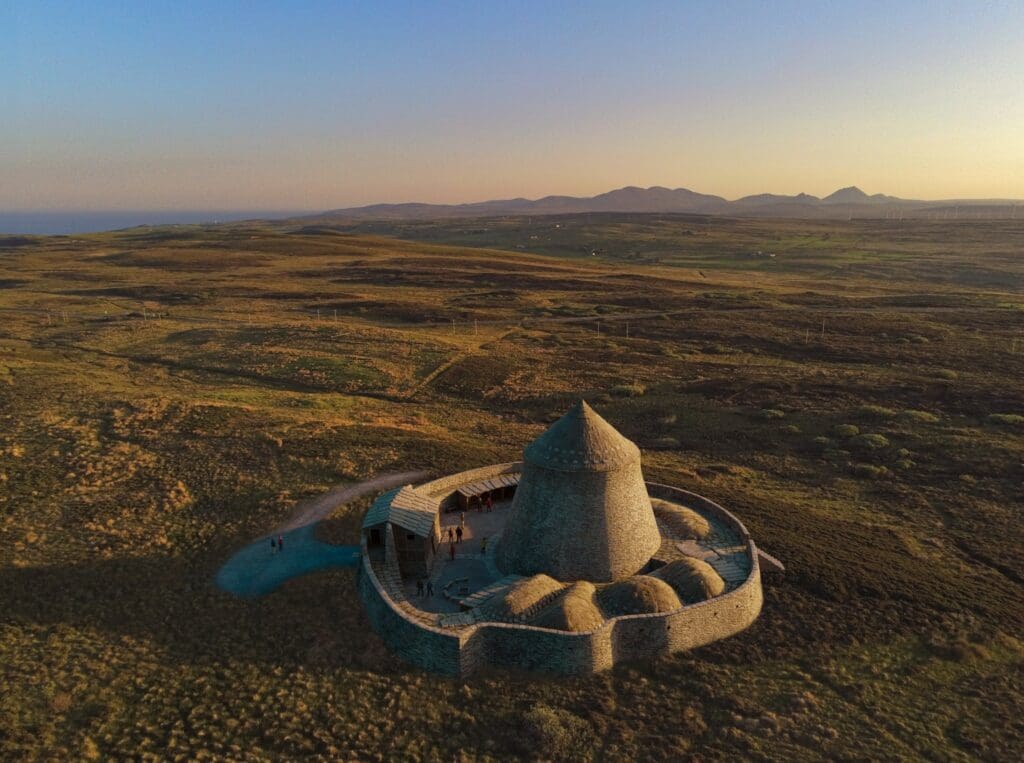 Artist's impression of the Caithness Broch's Project reconstructed broch to be built in the North Highlands with Ben More and Morven in the backdrop