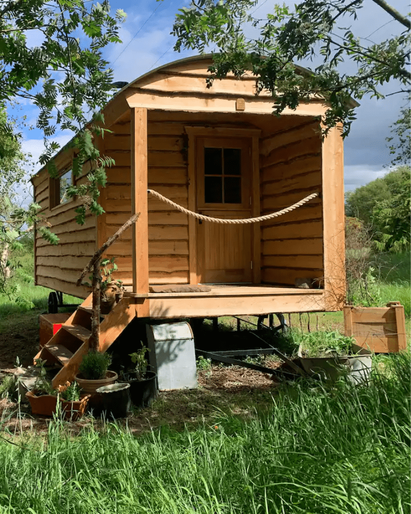 A rustic caravan in a green field in the North Highlands.