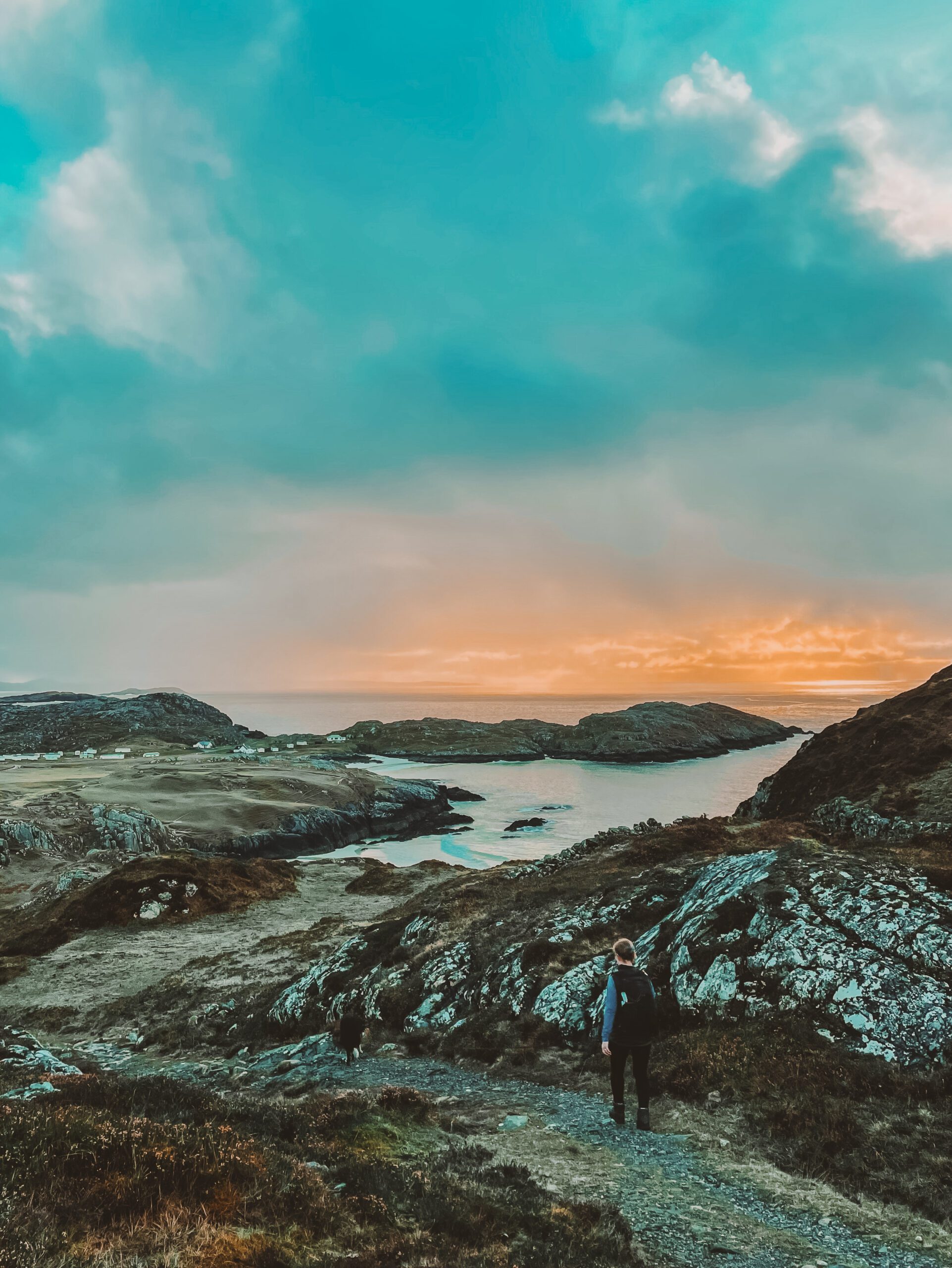 Walker walking towards Achelmivch, Sutherland at Sunset