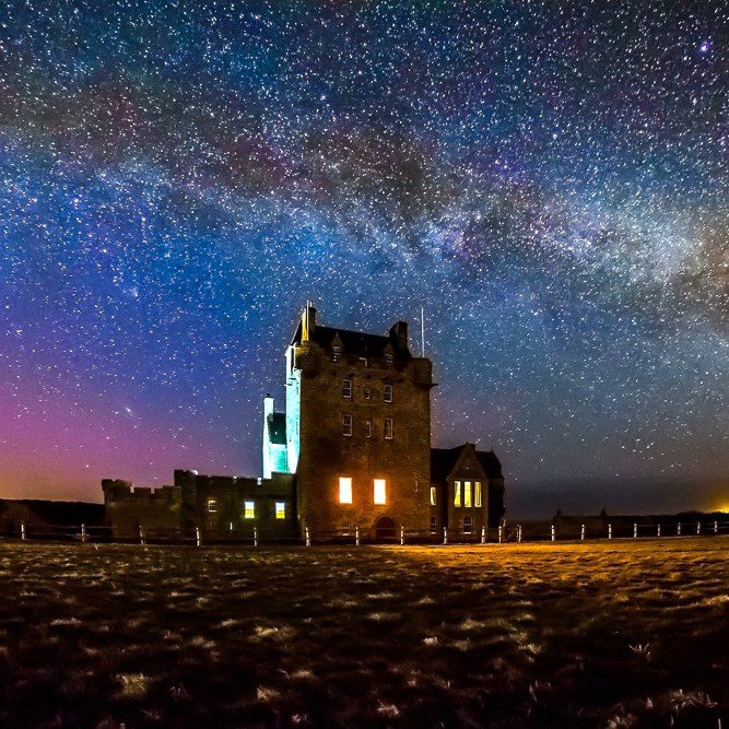 Ackergill Tower under sparkling night sky, Wick, Caithness, North Highlands. local heritage, castles in North Highlands