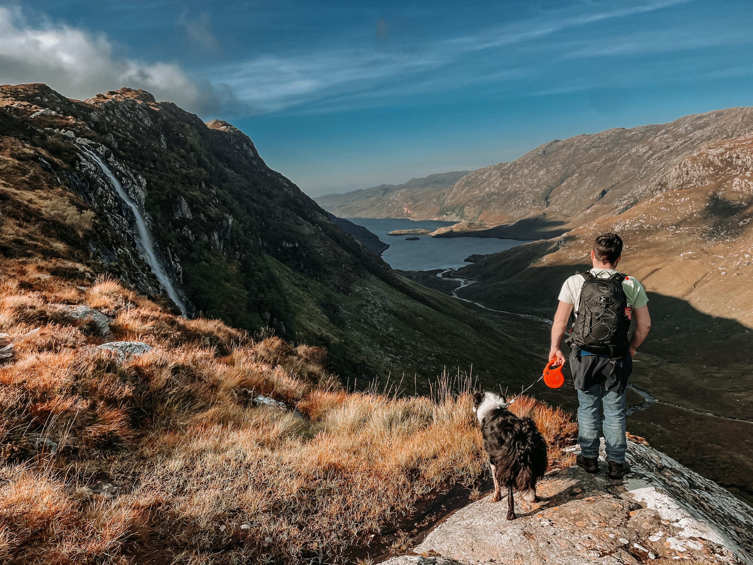 Dog and walker at Eas a' Chual Aluinn, Britain's highest waterfall in Sutherland, Scotland