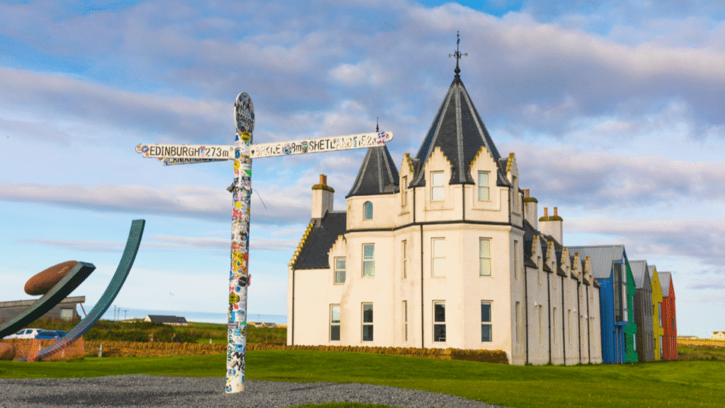 John O Groats, iconic John O'Groats signpost with John O'Groats Hotel in the background, Caithness, North Highlands