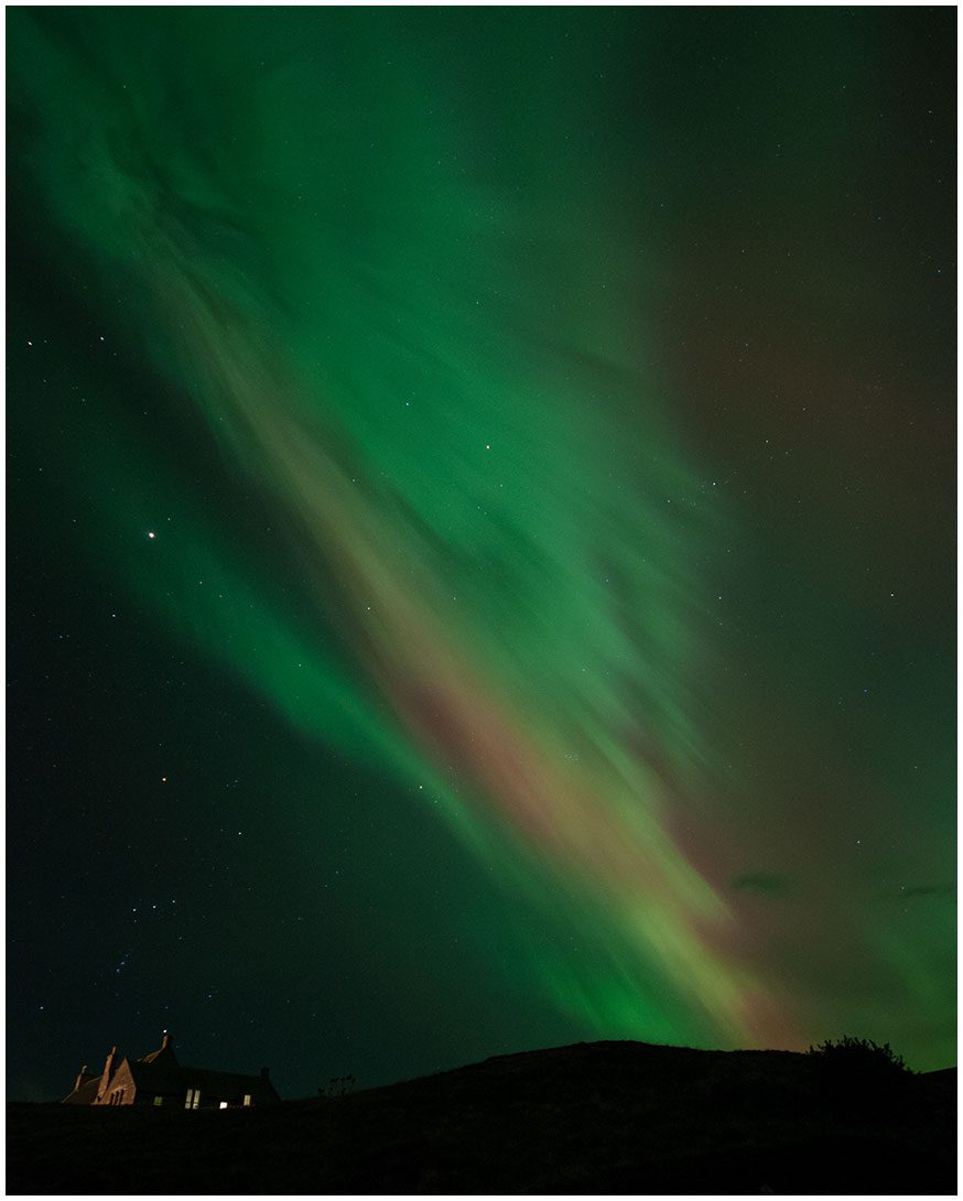 Aurora Borealis in the night sky over Melness School on the North Coast of Sutherland, North Highlands, near Caithness. Photography by Gary MacLeod.