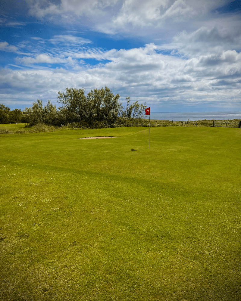 Lybster Golf Course, showing one of the holes with it's flag. in Caithness, North Highlands