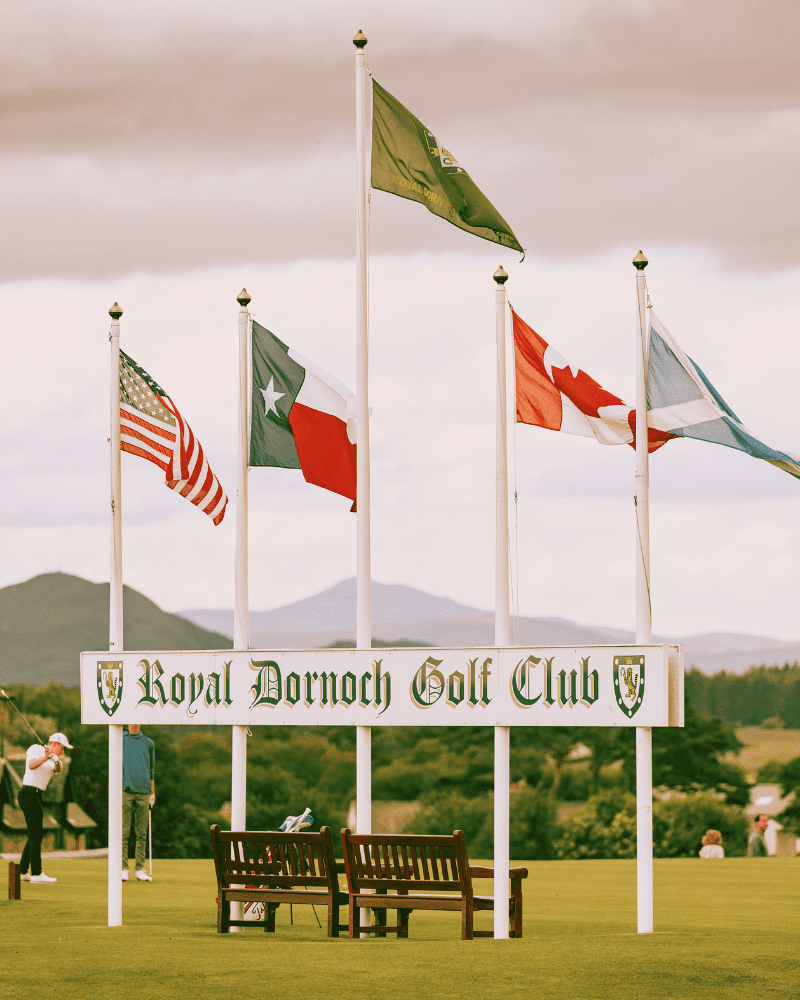 5 flag poles in front of a sign stating 'Royal Dornoch Golf Club', sutherland, North Highlands