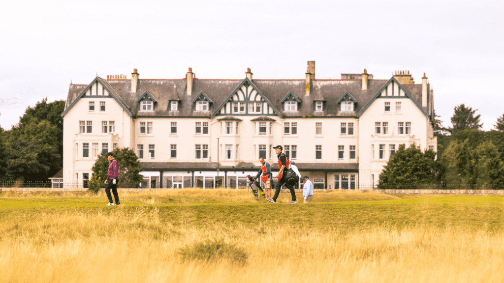 A group of golfers on the course with the Royal Dornoch Golf Club in the Background, Sutherland, North Highlands