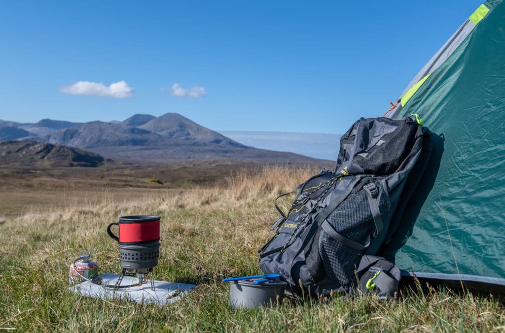 A back pack and tent on a grassy hill in the North Highlands